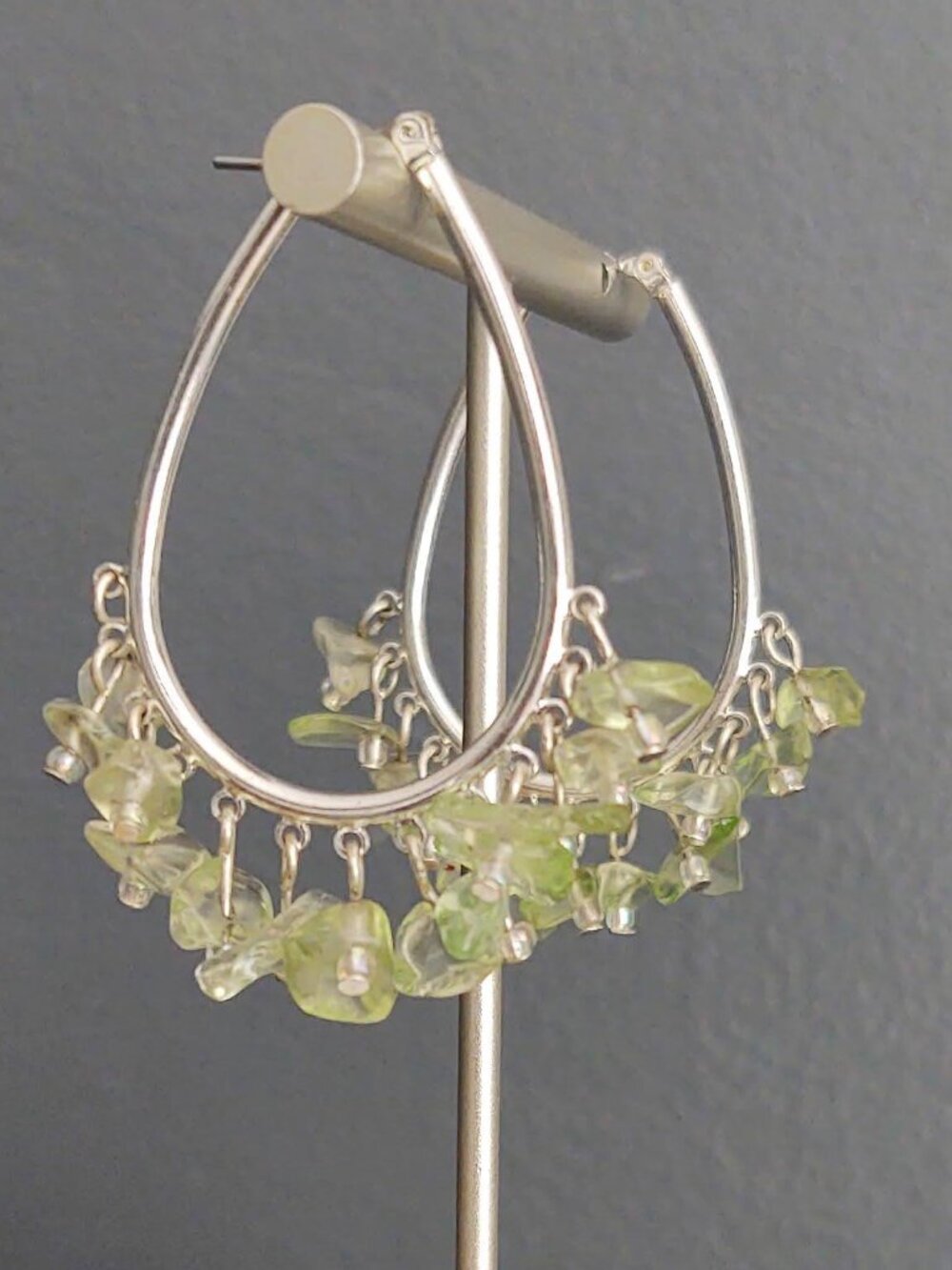 Silver earrings with green stone chip dangles